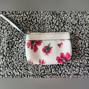 Cute wristlet. Off white with pink flowers. Excellent condition.